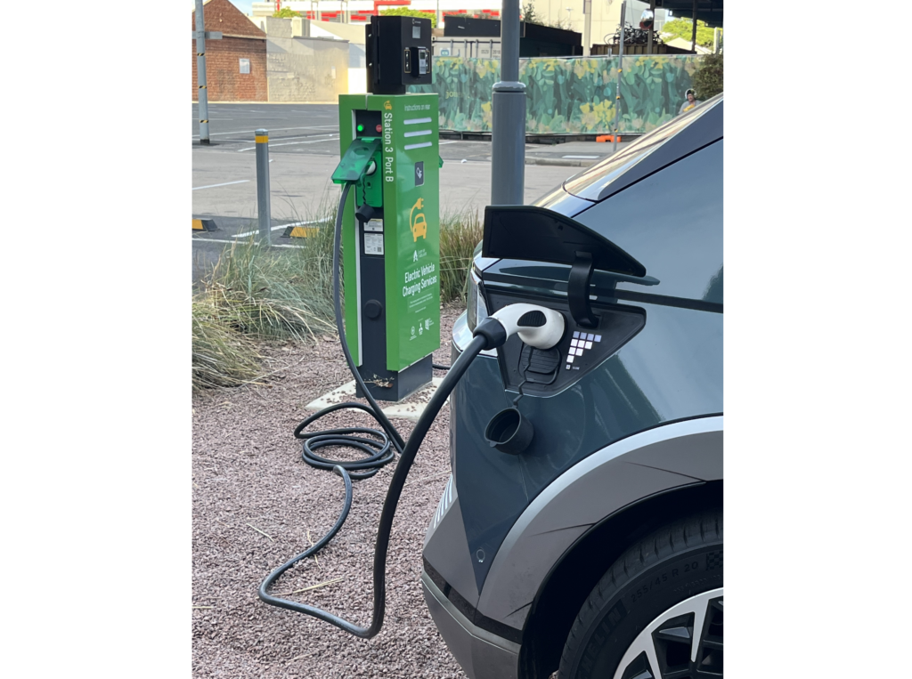 Photo of electric vehicle at charging station.